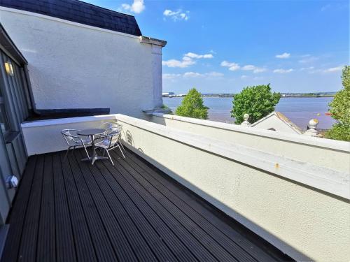 
a balcony with a view of the ocean at The Clarendon Royal Hotel in Gravesend
