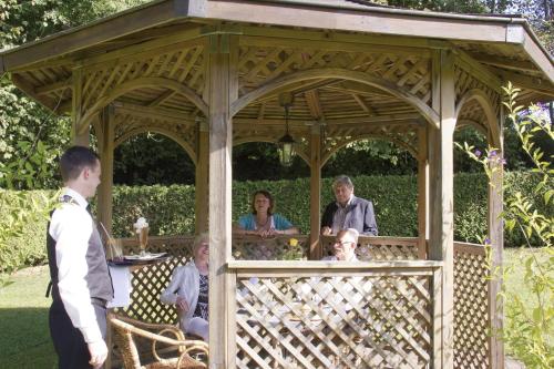 a group of people sitting in a gazebo at Hotel Jägerhof in Staatsbad Brückenau