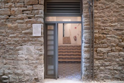 a doorway into a building with a door and stairs at NUEVO Katu Kale Apartamentuak CENTRO HISTORICO in Getaria
