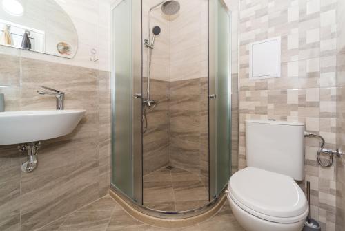 a bathroom with a shower and a toilet and a sink at Alma Apartment - Stylish 1BD Flat with Balcony by Flat Mаnager in Plovdiv