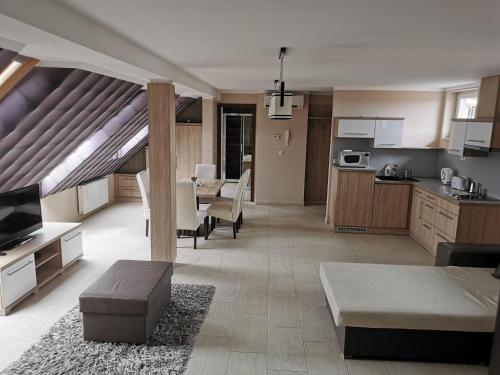 a large room with a kitchen and a living room at Szabó Lux Apartman in Sárvár