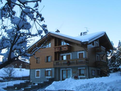 a house with snow on the roof at Baita al Pian in Bormio