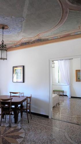 a dining room with a table and a bed at Le coccole in Genova