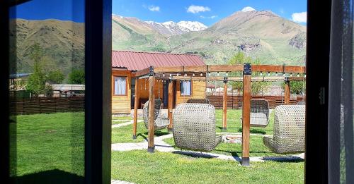 a view from a window of a yard with chairs at Hotel Migu Yard in Stepantsminda