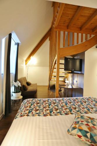 a bedroom with a bed and a living room at Best Western Le Pont d'Or in Figeac