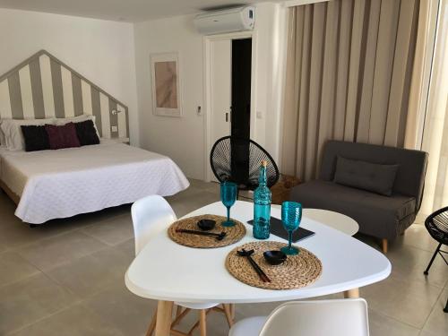 a living room with a bed and a table and chairs at Casa do Joaquim da Praia in Nazaré