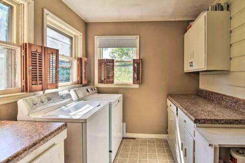 a kitchen with a washing machine and a sink at Pet-Friendly Columbus Cottage with Deck, Near Lakes! in Columbus