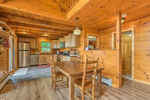 a kitchen with a wooden table and chairs in a cabin at Catskills Home with Deck and Game Room 14 Mi to Ski! in Prattsville