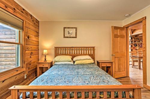 a bedroom with a bed and two tables and a window at Catskills Home with Deck and Game Room 14 Mi to Ski! in Prattsville