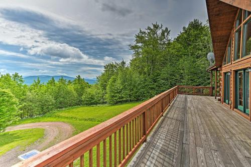 a wooden deck on the side of a house at Catskills Home with Deck and Game Room 14 Mi to Ski! in Prattsville