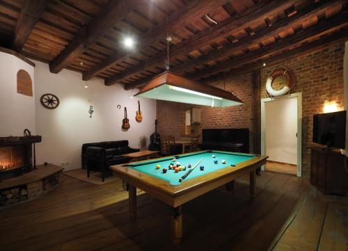a pool table in a living room with a ceiling at Penzion Kamenne Slunce in Telč