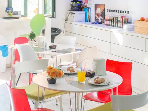 a restaurant with tables and chairs with food on them at Apartments Windrose in Kotor