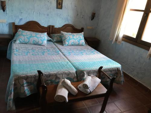a bedroom with a bed with towels on a table at Casa Rural Cortijo La Ajedrea in Siles
