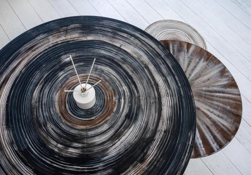 an overhead view of three circular wooden tables at Pnoe in Mýkonos City