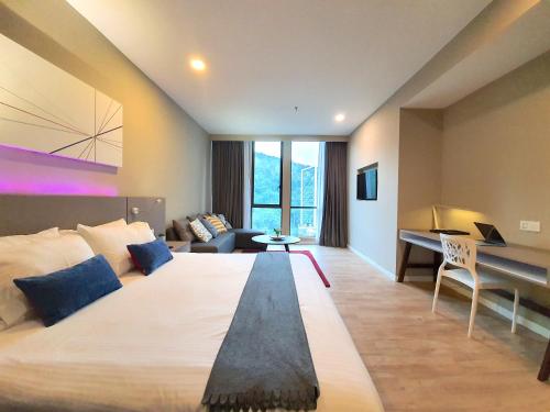 a large bedroom with a large bed and a desk at Empire Damansara Hotel Suites by Beestay in Petaling Jaya