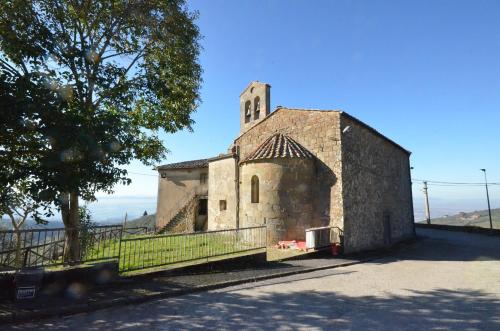 an old stone church with a tower on a hill at Casa Mela in Vinci