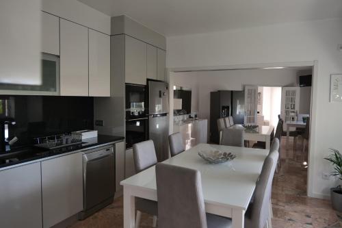 a kitchen and dining room with a white table and chairs at Casal da Rita Natura in Santarém