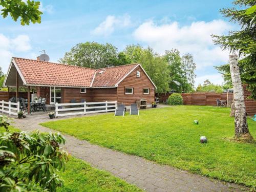a barn with a yard and a house at 5 person holiday home in Middelfart in Middelfart
