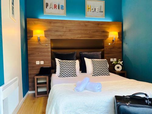 a bedroom with a large bed with blue walls at Hôtel Clairefontaine in Paris