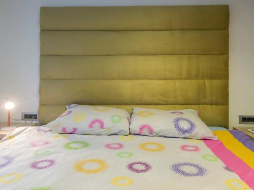 a bed with two pillows on top of it at Apartments Windrose in Kotor