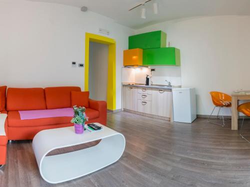 a living room with a couch and a table and a kitchen at Apartments Windrose in Kotor