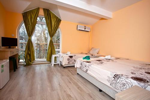 a bedroom with two beds and a window at Familly hotel Randevu in Kranevo