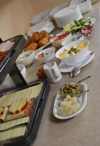 a table with a bunch of different types of food at Alfréd Panzió in Budapest