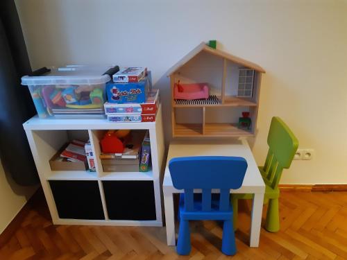 a toy desk and a table and a chair at Apartment in Old Town - view of Mariacki Church in Gdańsk