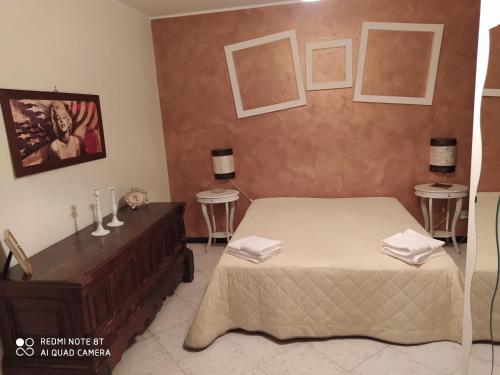 a bedroom with a bed and a dresser and two tables at Panorama Lucano in Altamura