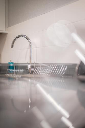 a sink in a kitchen with a faucet at The Knight Residence by Mansley in Edinburgh