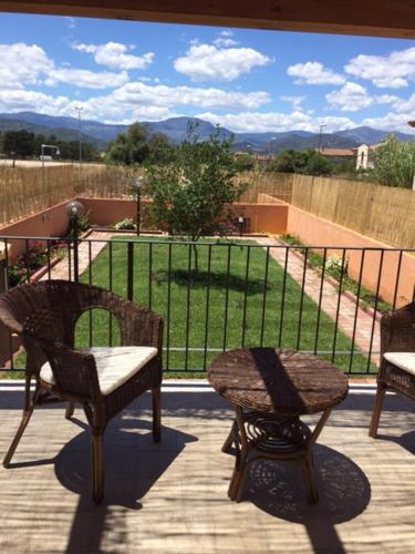 a patio with two chairs and a view of a park at Villino Enzo 350 mt Baia di Porto Frailis in Àrbatax
