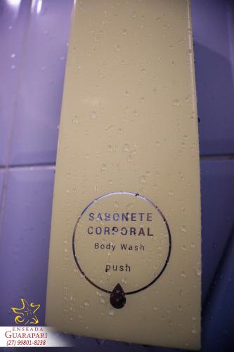 a white surfboard with a sticker on it at MAIOR NOTA - 2 Quartos com AR CONDICIONADOS SPLIT, Air Fryer, Wi-Fi, Disney Plus, Star Plus, HBO Max, Guarda Sol, Cadeiras de Praia, Caixa Térmica, Churrasqueira, Rede para Descanso e Chuveirão - 8 pessoas - CONFORTO Máximo - Melhor Localização!! in Guarapari