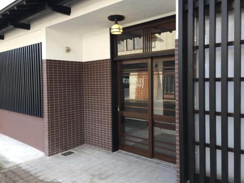 an entrance to a building with a glass door at KINOSAKI KNOT - Vacation STAY 83610 in Toyooka