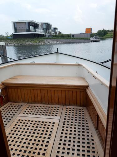 a boat with a bed in the middle of the water at Privé B&B Motorsailer Rataplan in Kamperland