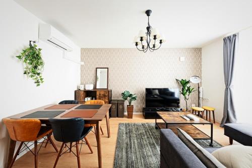 a living room with a table and a couch at Sapporo - Apartment - Vacation STAY 7939 in Sapporo