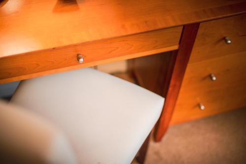 a wooden desk with a white chair under it at The Knight Residence by Mansley in Edinburgh