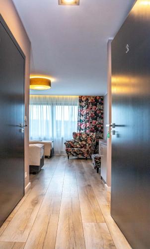 a hallway with a living room with a wooden floor at Ranczo Daniela in Pobiedziska