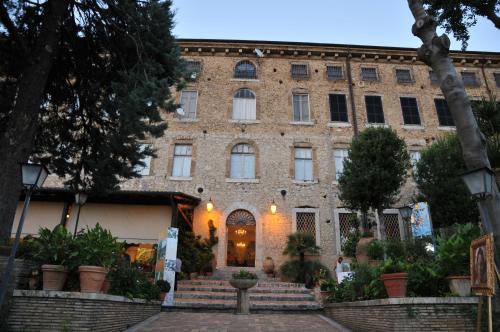 a large brick building with stairs in front of it at Hotel Il Cavalier D'Arpino in Arpino