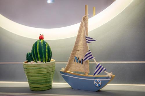 a toy boat and a cactus on a table at Apartments Olivia & Navy, Šilo in Šilo