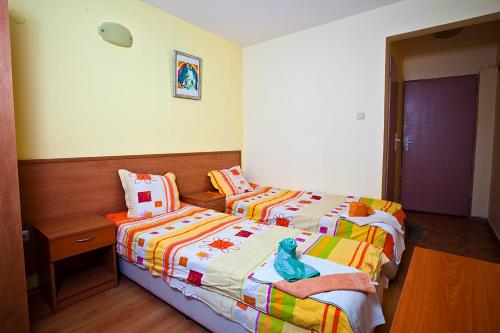 a bedroom with two beds and a night stand at Familly hotel Randevu in Kranevo
