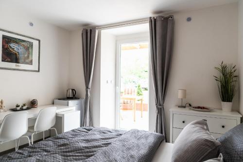 a bedroom with a bed and a sliding glass door at Penzion U Pivovaru in Děčín