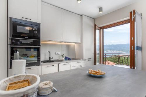 a kitchen with a table with a bowl of food on it at Apartments Olivia & Navy, Šilo in Šilo