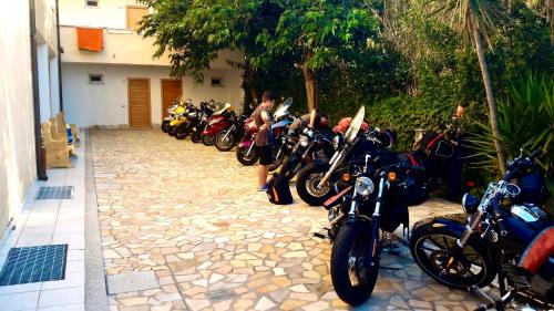 motorcycles parked in front of a building at Meta Hotel in Santa Teresa Gallura