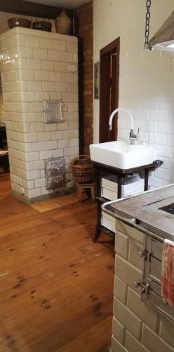 a bathroom with a white sink and a counter at Dom Dziadka in Janów Podlaski