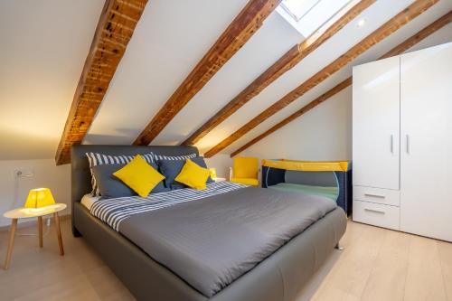 a bedroom with a bed with yellow pillows at Fran Center Apartments (Square) in Pula