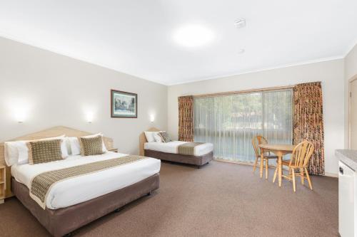 Ένα ή περισσότερα κρεβάτια σε δωμάτιο στο Presidential Motel
