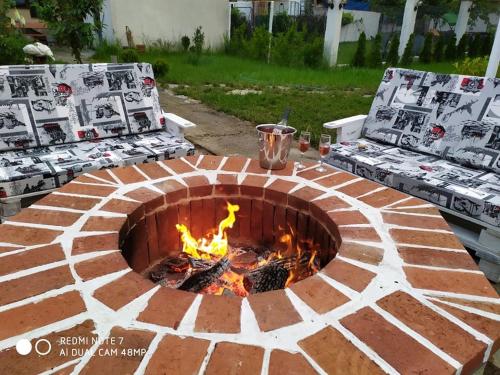 a fire pit in the middle of a yard at Family Hotel Malibu in Chernomorets