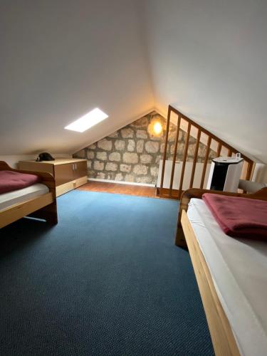 a large room with two beds and a staircase at Apartments RGETO in Ston
