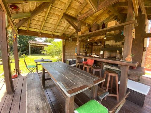 a wooden table and chairs on a wooden deck at Casa Amigable y Disfrutable in La Coronilla