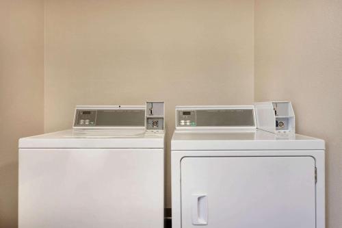 two microwaves are sitting on top of a refrigerator at Super 8 by Wyndham Ruston in Ruston